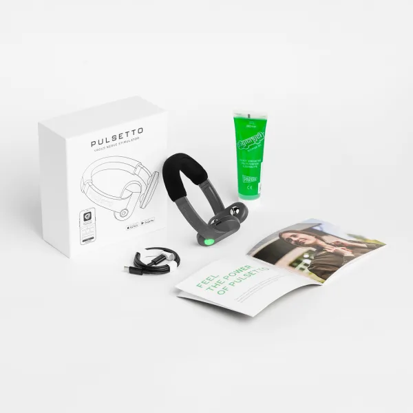 The Pulsetto Lite kit laid out: the box marked PULSETTO vagus nerve stimulator, the device, a green conductive gel tube, a USB-C cable and a printed guide